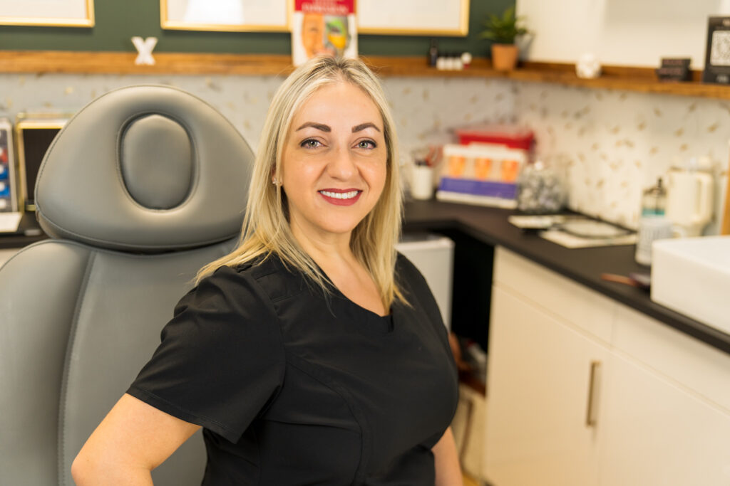 Lavi Londonson sitting in her client chair at her office for patient care in Peoria, AZ