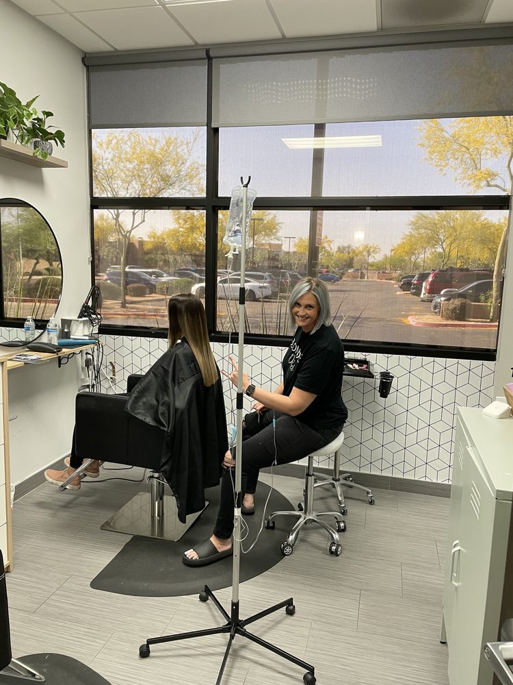 A client receiving IV therapy while getting her hair done in a neighboring office to Aesthetics by Lavi.