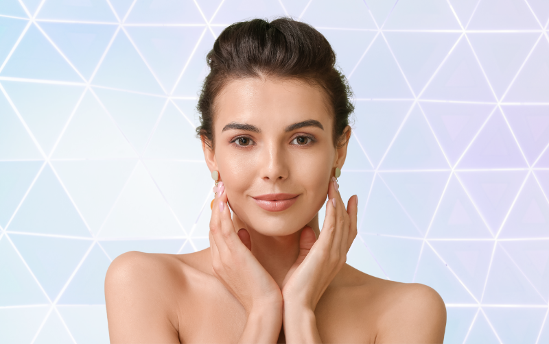 Happy woman with beautiful skin in front of a geometric image representing the act of building a foundation of collagen under the skin.